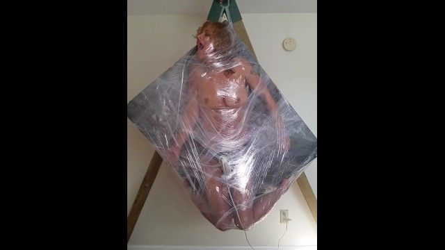Quinn fastened in plastic wrap . hanging out cumming.